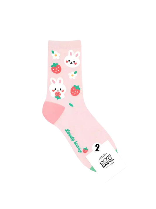 Pink socks with bunny and strawberry design on a light gray background
