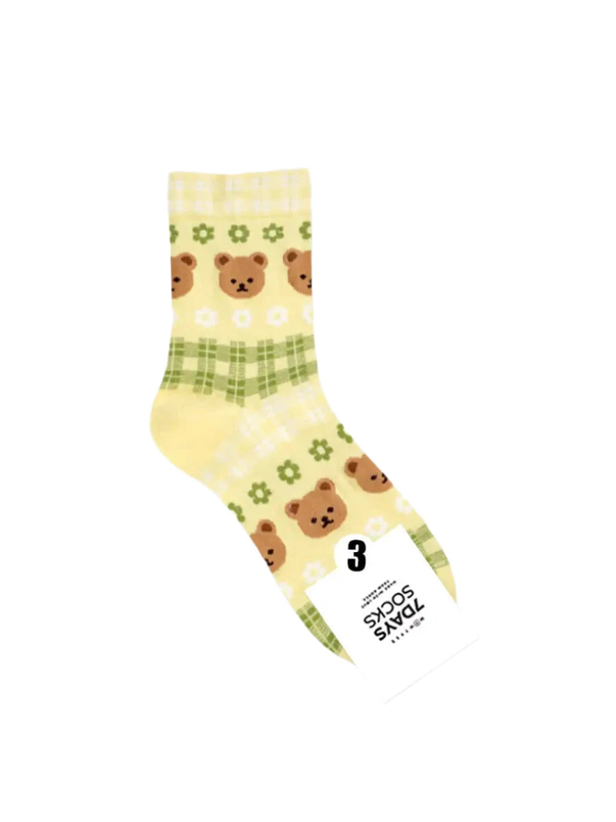 Colorful socks with bear pattern and a tag on a light gray background