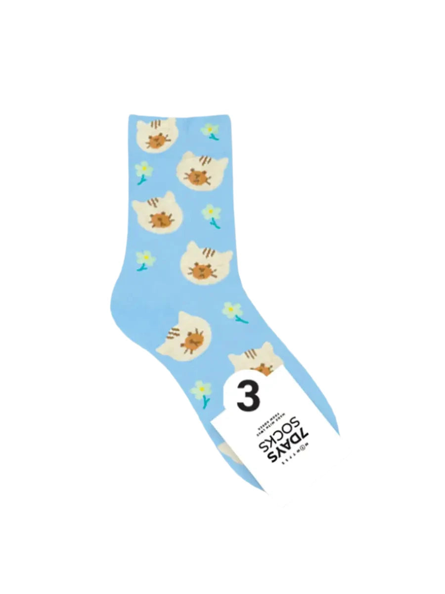Light blue sock with cat illustrations on a white background