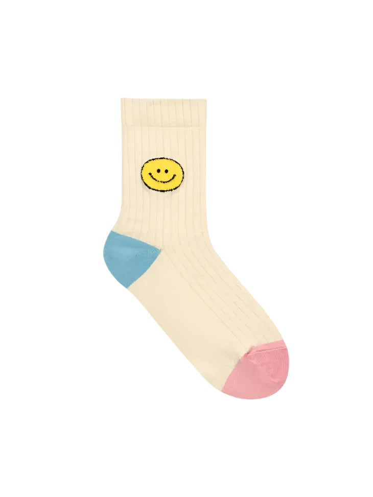 Beige sock with a smiley face design on a white background