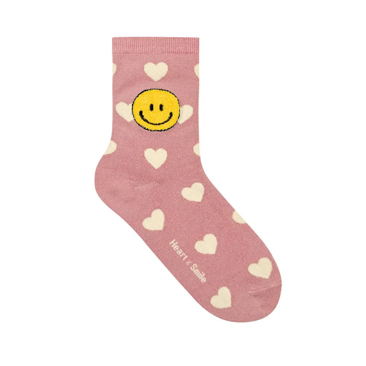 Pink sock with smiley face and heart patterns on a white background