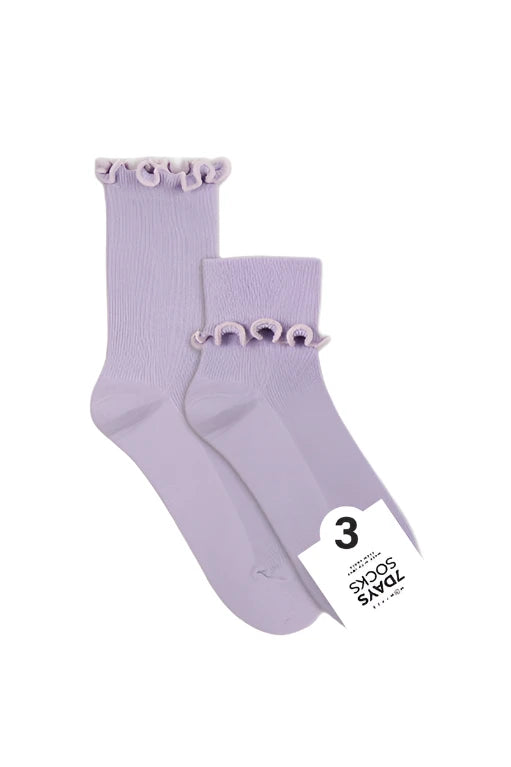Pair of light purple socks with ruffled top on a white background