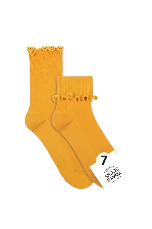 Pair of mustard yellow socks with ruffled top on a white background