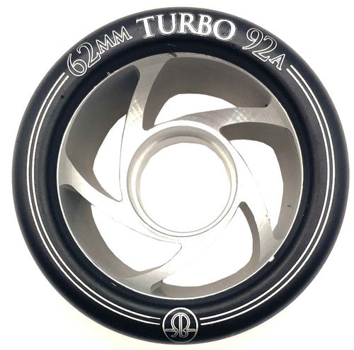 Close-up of a Turbo Wheel from Sunshine Rollers, measuring 62mm with an aluminum hub and a black outer rim. This speed derby wheel showcases a unique spiral fan-like design and is crafted from premium urethane compounds for optimal performance.